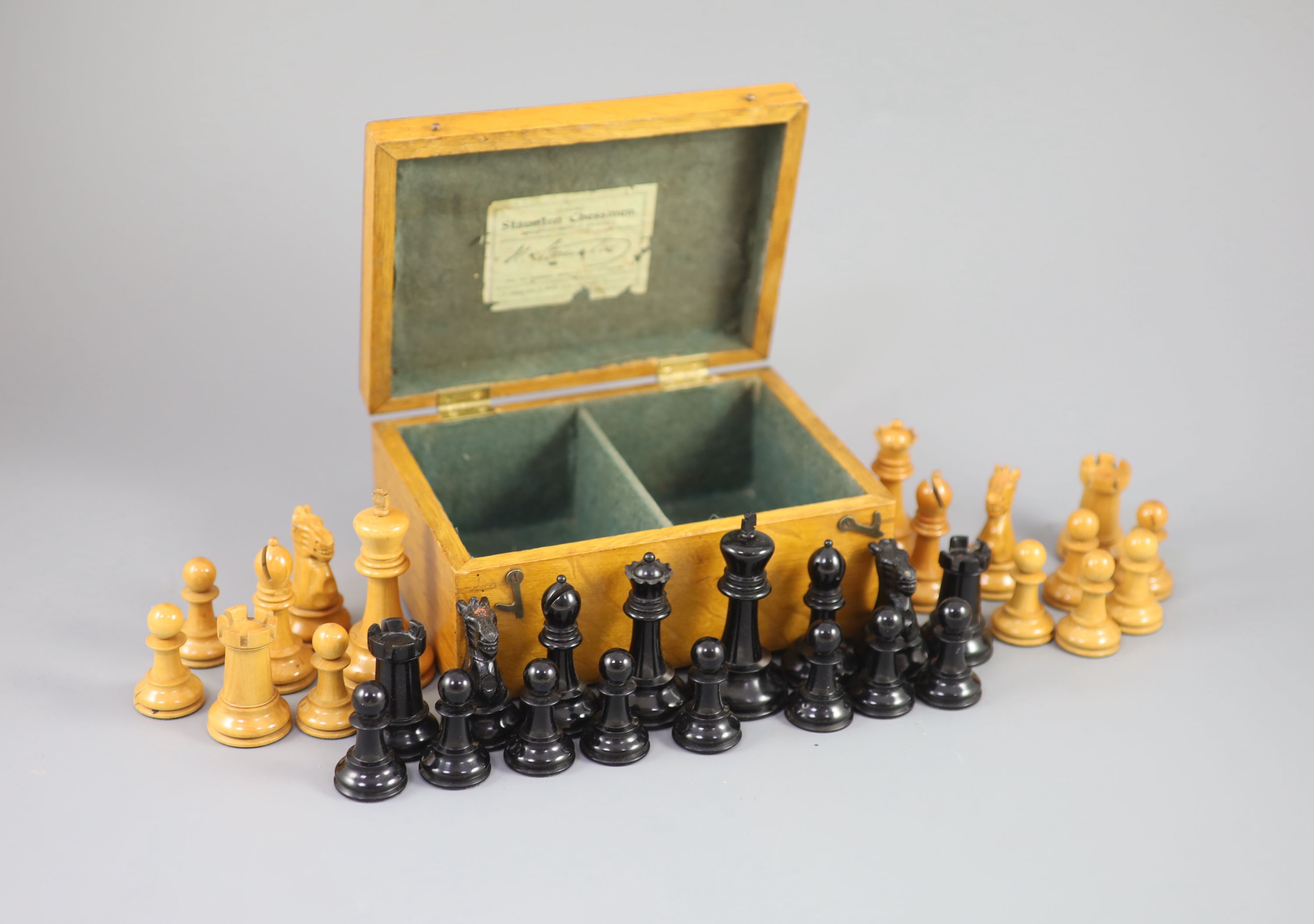 A Jaques & Son Staunton 3 1/2 boxwood and weighted chess set in original golden oak box, c.1910, 8 x 5.75 x 3.5in.